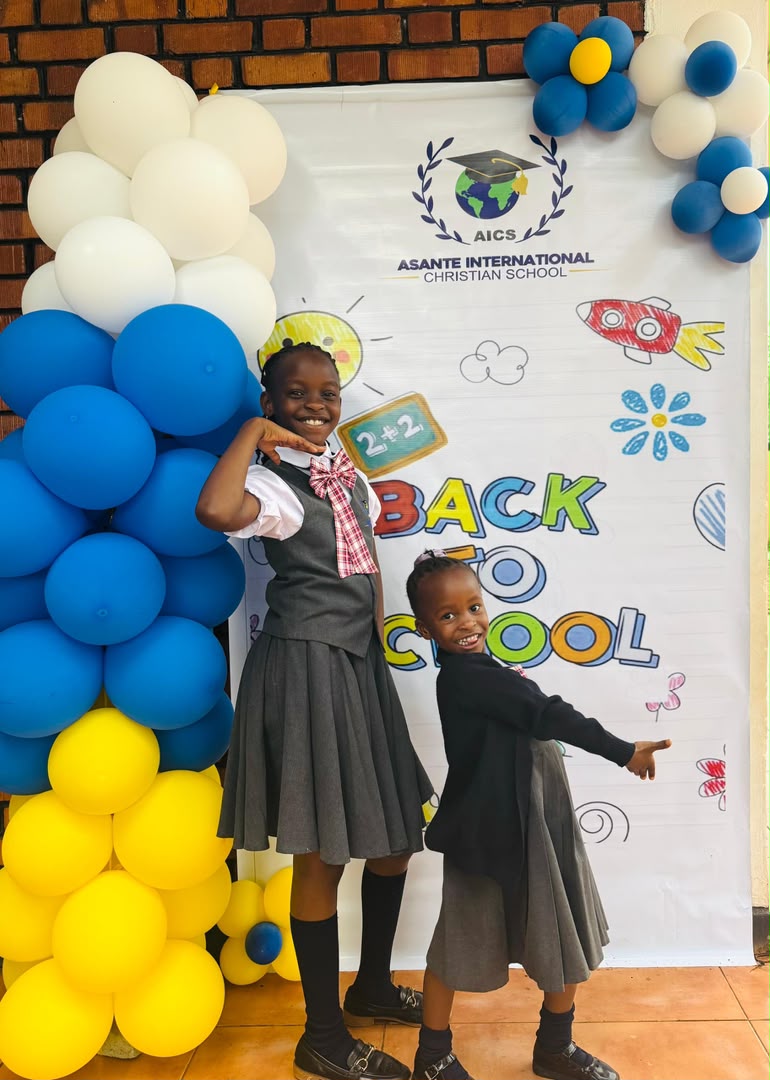 AICS pupils at the school welcome backdrop