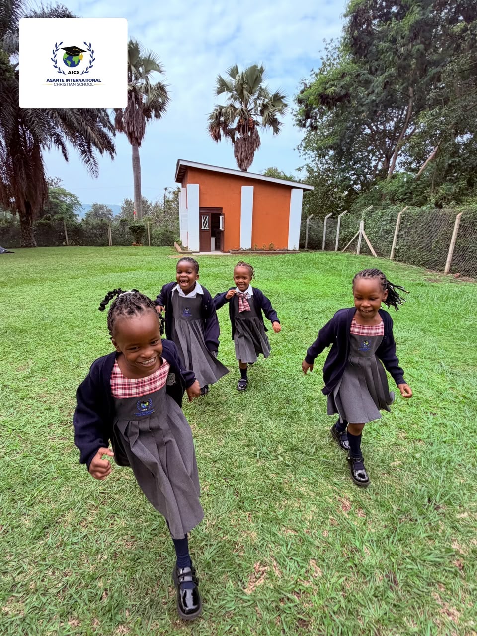 Joyful AICS early years pupils running outdoors